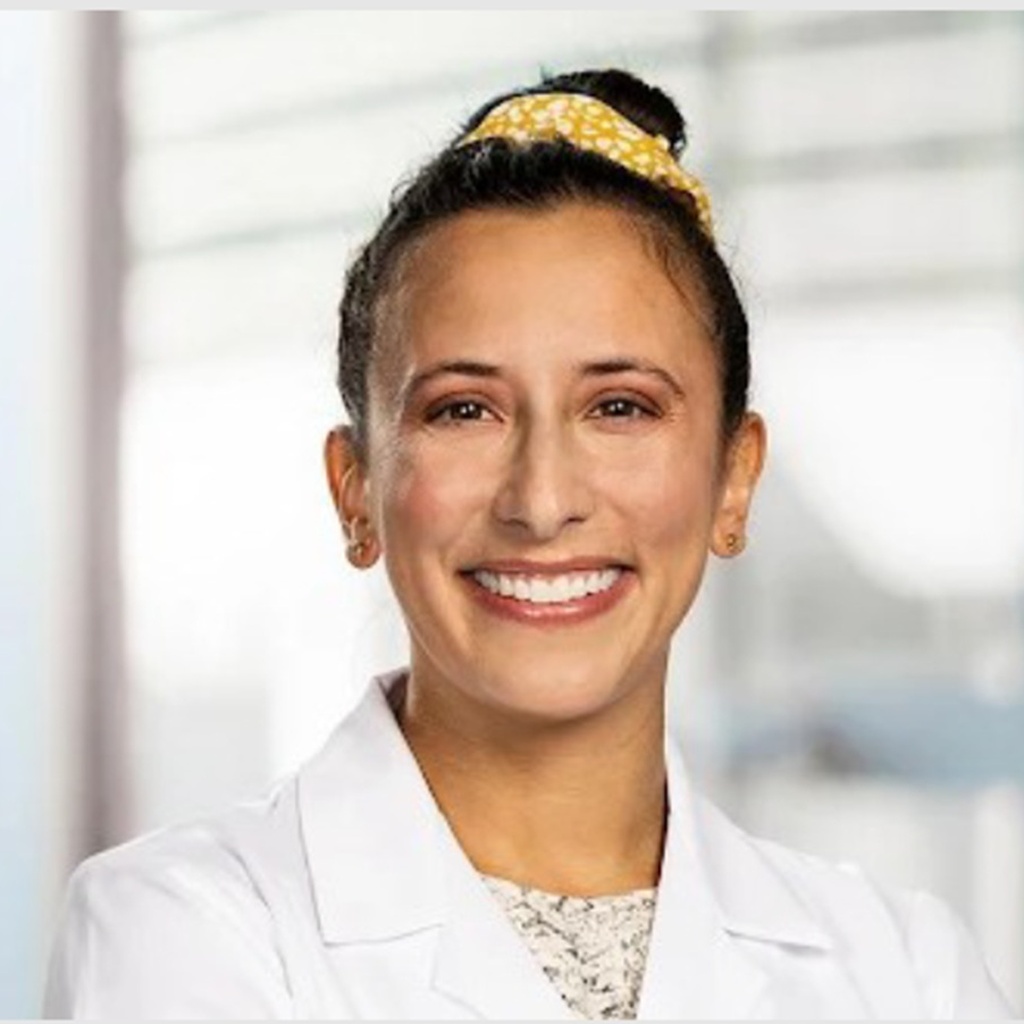 Dr. Zuleikha Tyebjee wearing a white coat